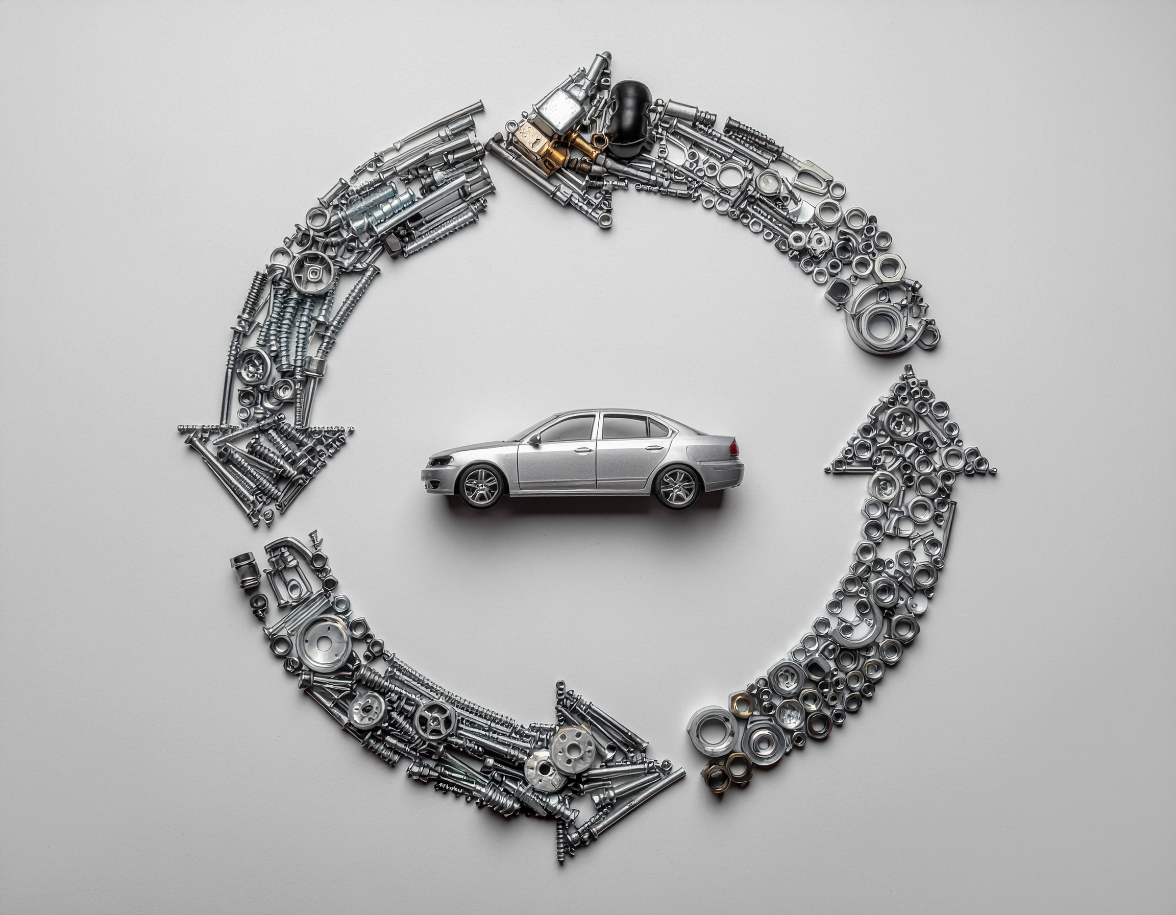 Car parts lifecycle: Arrows made of nuts/bolts circle a toy car. Old vehicles to new products.