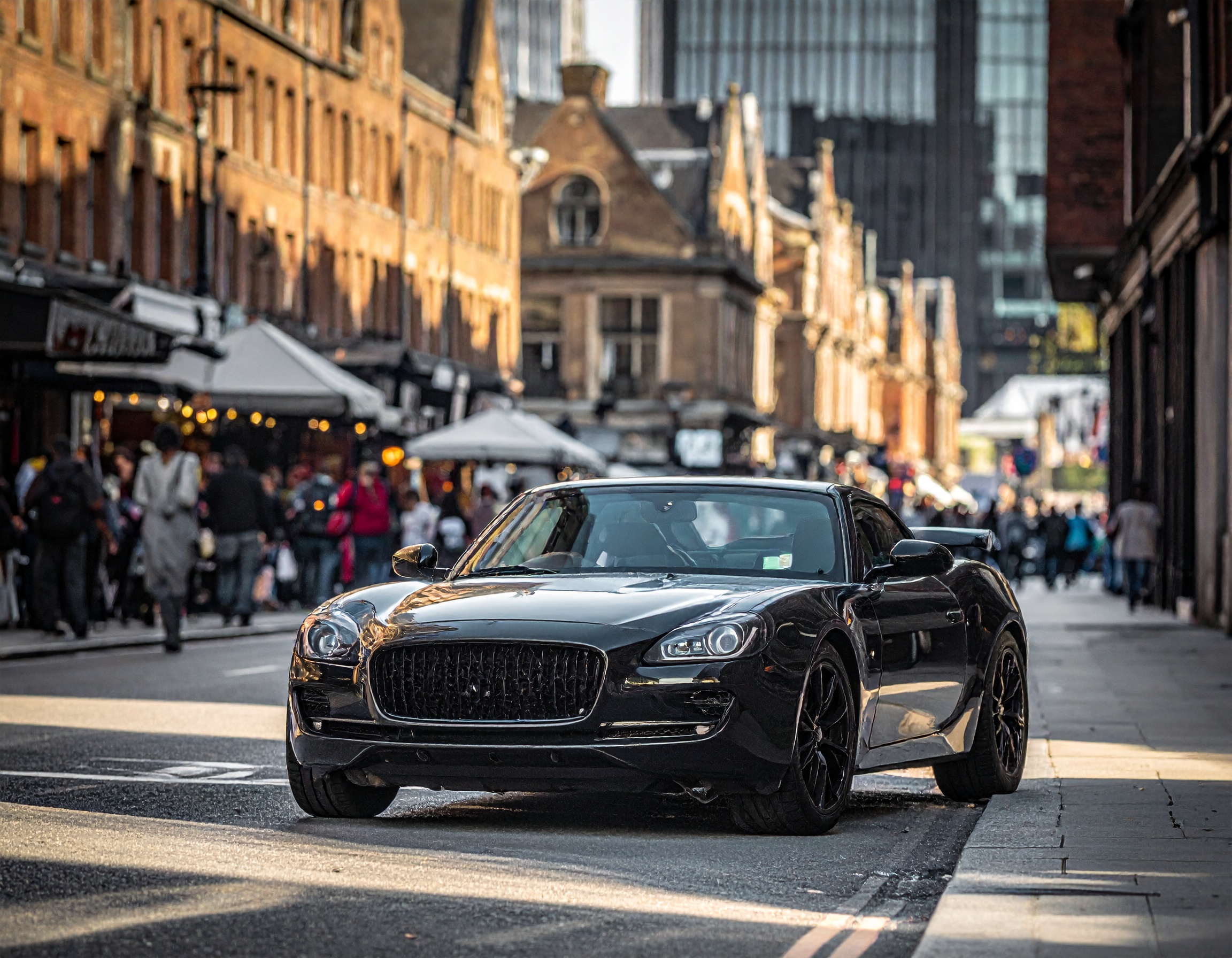 Black sports car parked on a London street. "How to Sell Your Car in London" guide image.